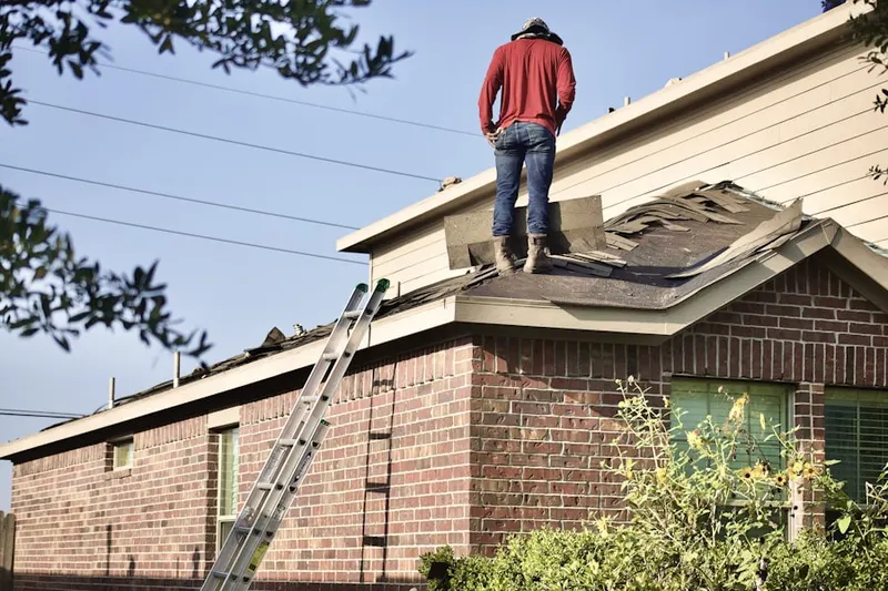 Professional roofer working on a residential roof in Overlook